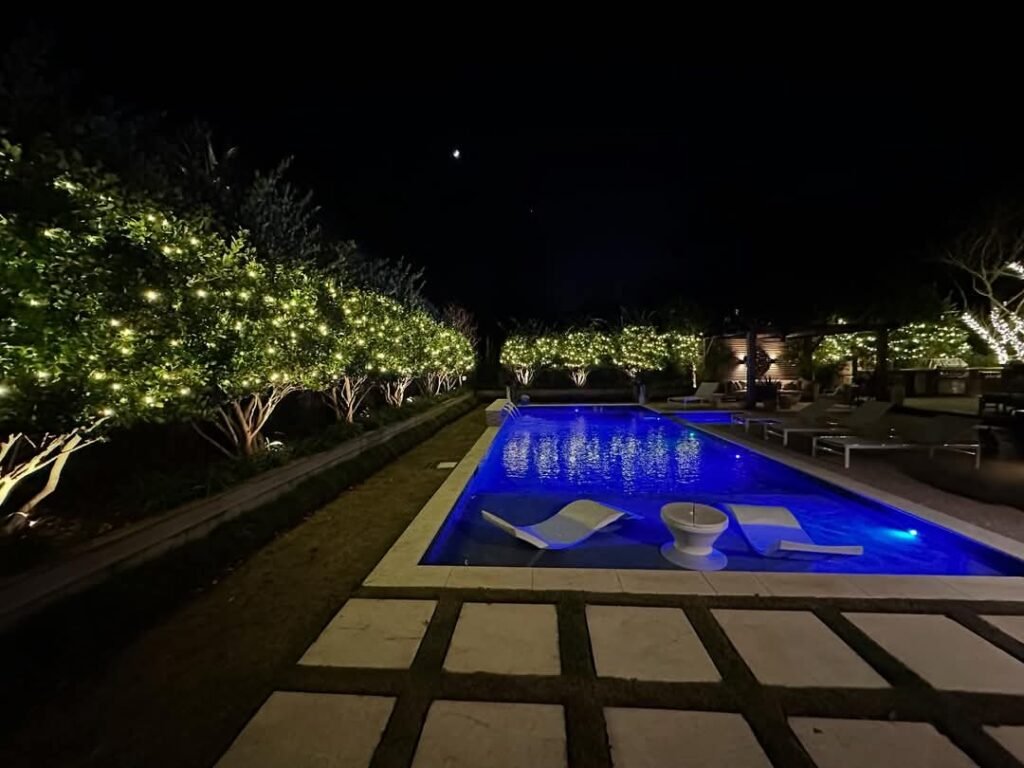 Christmas lights around a pool in Compass Pointe