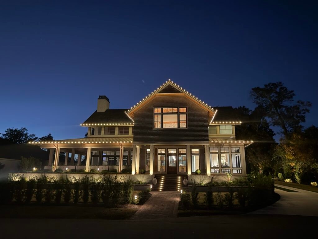 Warm white Christmas lights on a craftsman-style home by Shark Illumination
