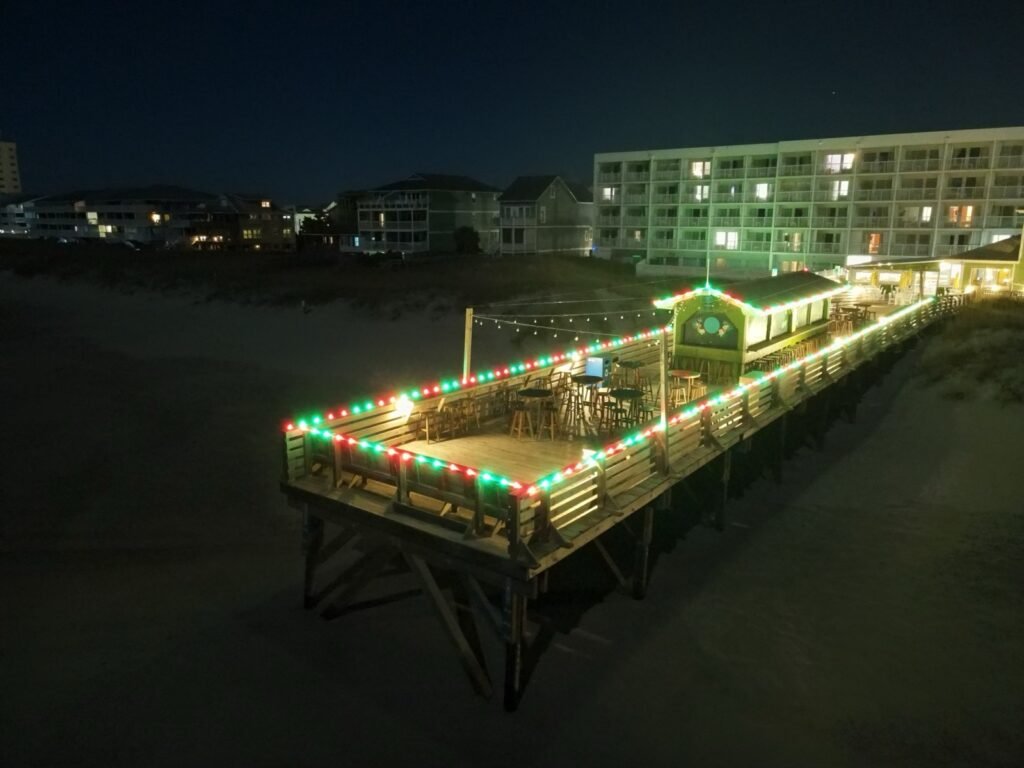 Aerial view of Christmas lights on a dock in Wrightsville Beach by Shark Illumination
