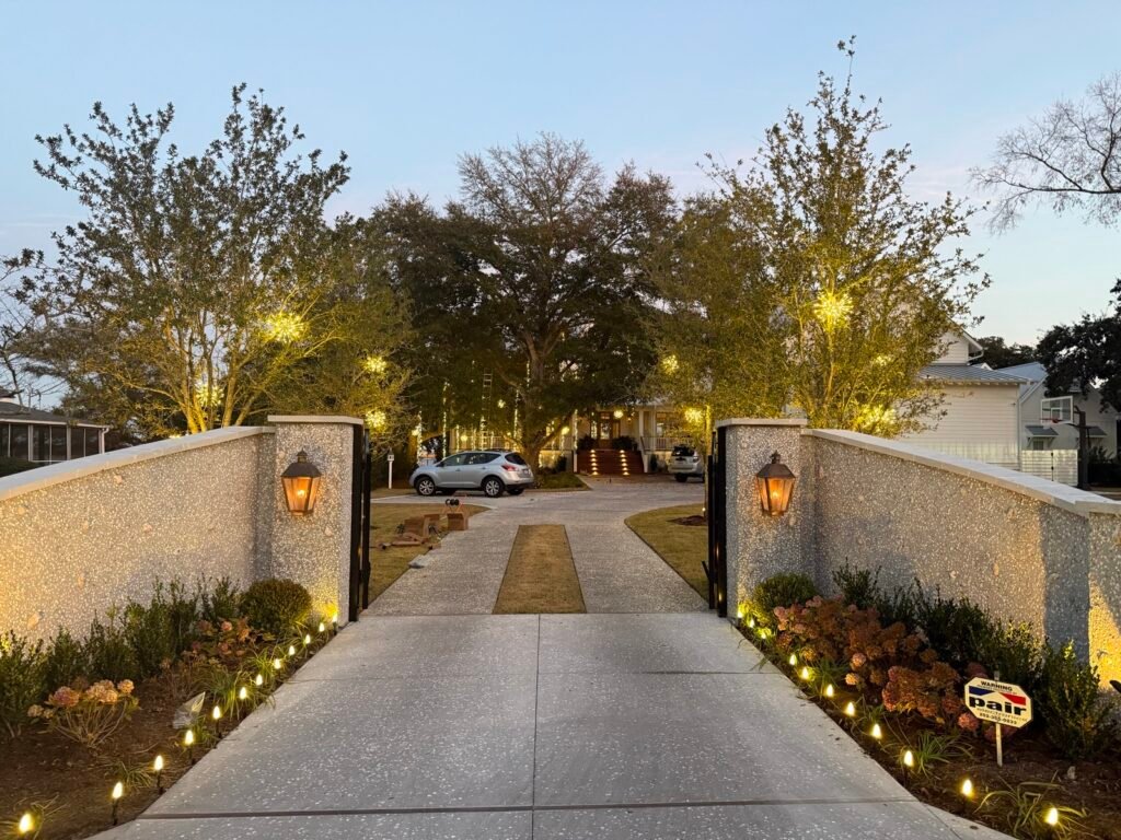 Christmas lights and garland on a gated estate entrance by Shark Illumination