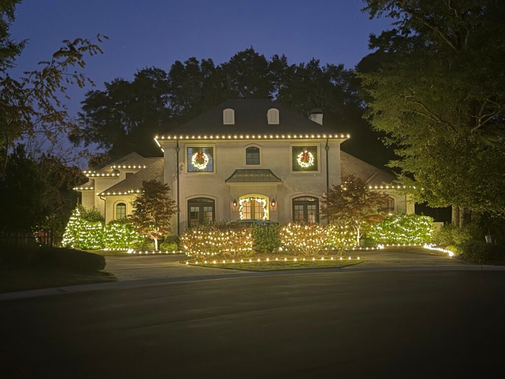 Christmas roofline lights and wreaths on a large home by Shark Illumination