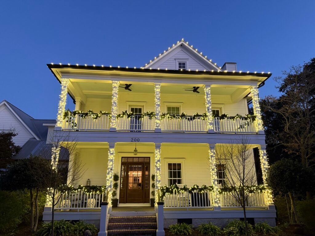 Christmas lights on a two-story home with porches by Shark Illumination