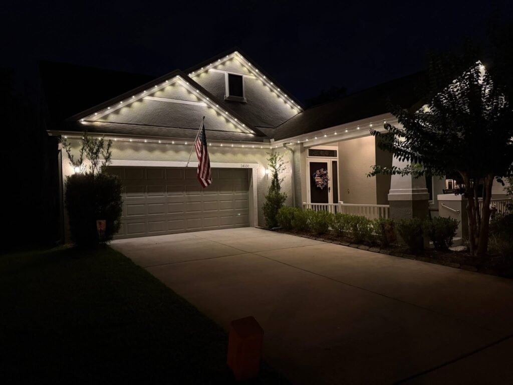 Warm white permanent lighting on a garage roofline by Shark Illumination