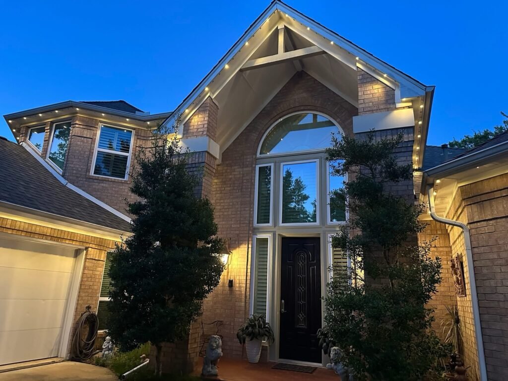 Permanent roofline lighting on a home at blue hour by Shark Illumination